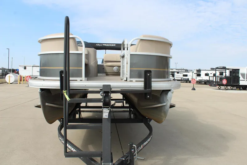 Slide: The Image of 2022 Sun Tracker Party Barge 18 DLX pontoon boat on trailer in parking lot. - 2