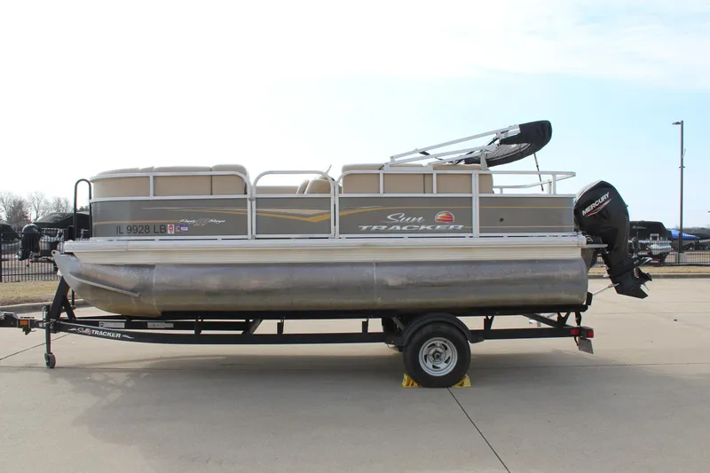 Slide: The Image of 2022 Sun Tracker Party Barge 18 DLX pontoon boat on trailer, side view. - 4