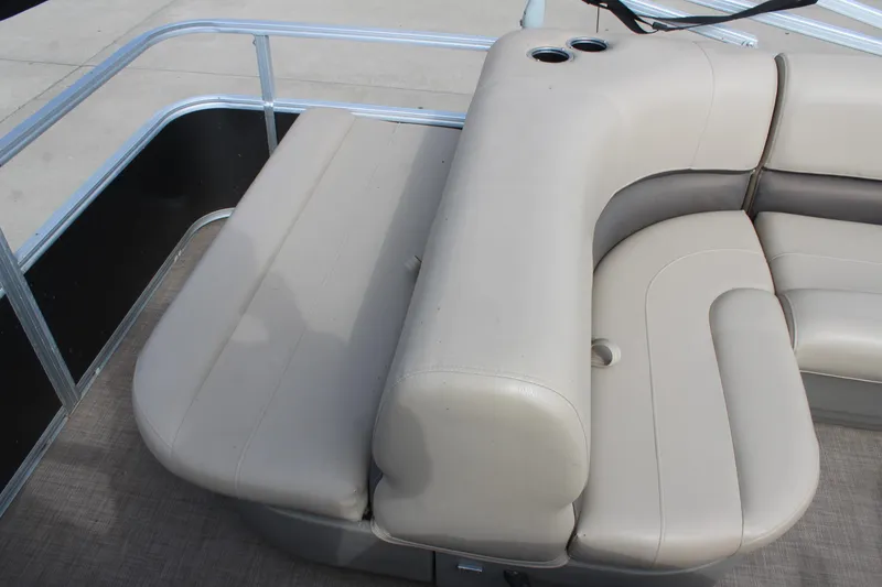 Slide: The Image of 2022 Sun Tracker Party Barge 18 DLX, beige seating area with cup holders. - 9