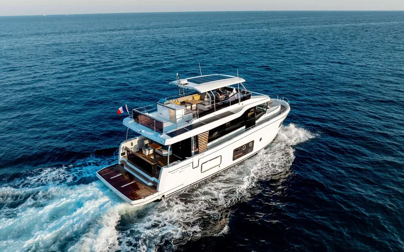 The Image of 2026 Beneteau Swift Trawler 54 cruising on open sea, rear view. - 1