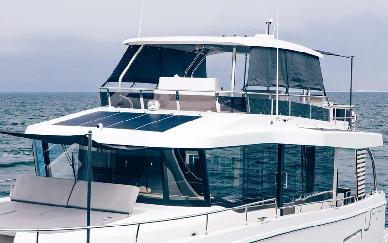 Slide: The Image of 2026 Beneteau Swift Trawler 54 on open water, showcasing modern design and spacious deck. - 6