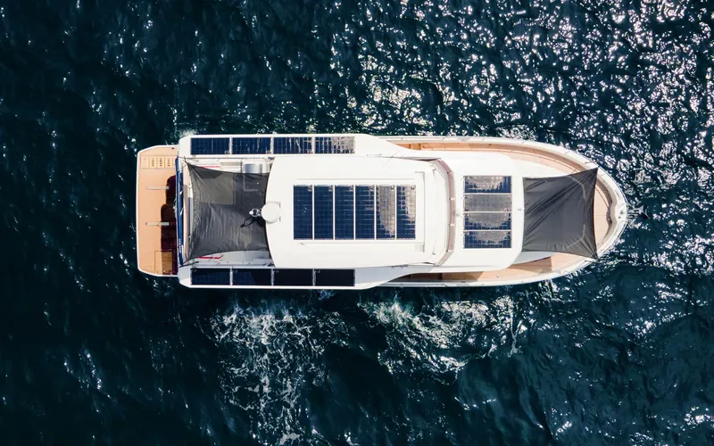 Slide: The Image of Aerial view of 2026 Beneteau Swift Trawler 54 cruising on open water. - 8