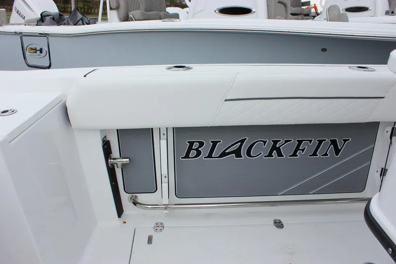 Slide: The Image of 2023 Blackfin 252 CC boat interior with logo and seating area. - 10