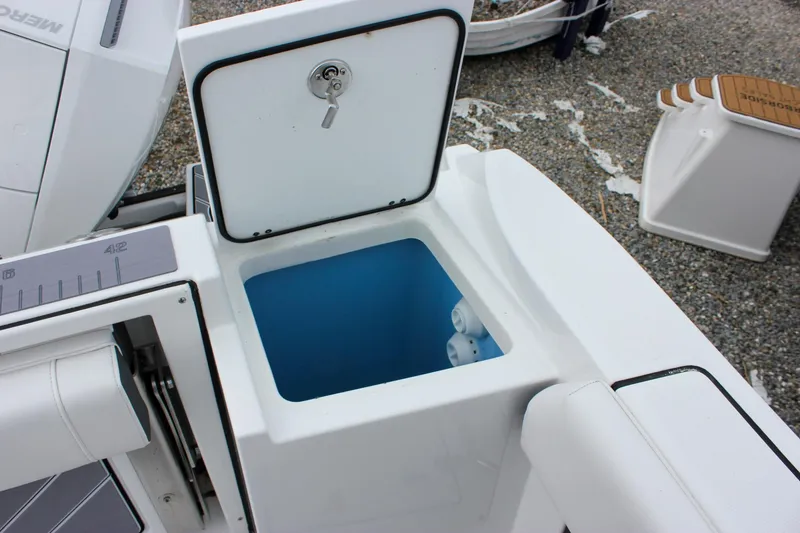 Slide: The Image of Open storage compartment on 2023 Blackfin 252 CC boat, featuring a secure lockable lid. - 12