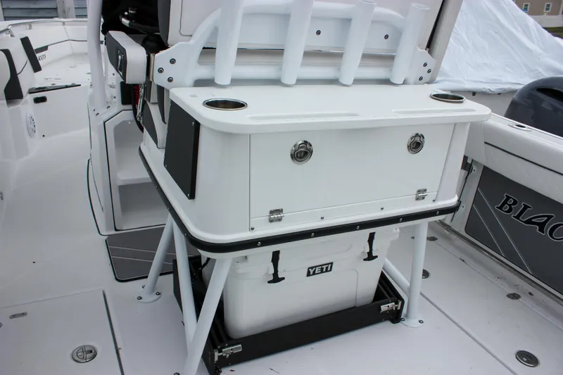 Slide: The Image of 2023 Blackfin 252 CC boat interior with Yeti cooler and rod holders. - 13
