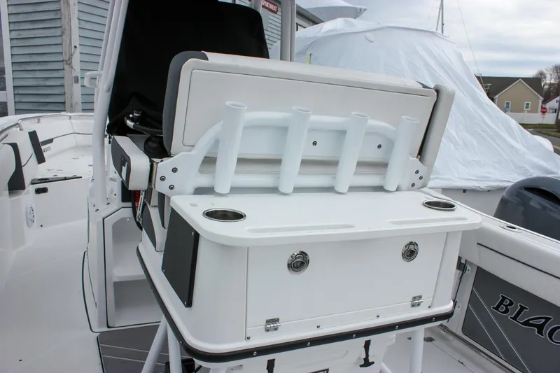 Slide: The Image of 2023 Blackfin 252 CC boat interior with rod holders and storage compartments. - 14