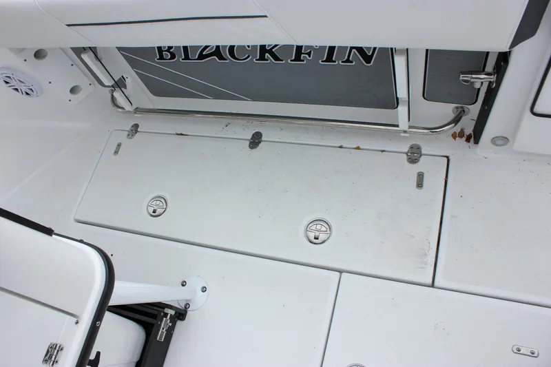 Slide: The Image of 2023 Blackfin 252 CC boat deck with storage compartments and seating area. - 18