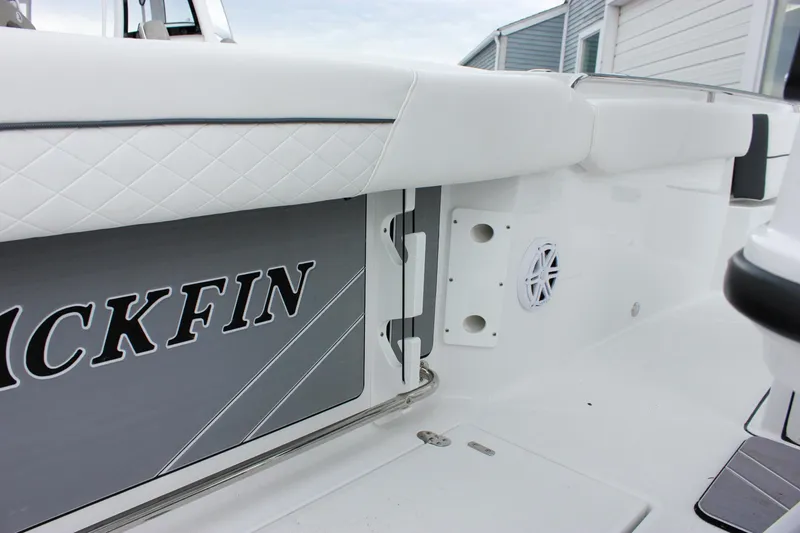 Slide: The Image of 2023 Blackfin 252 CC boat interior with white seating and speaker detail. - 19