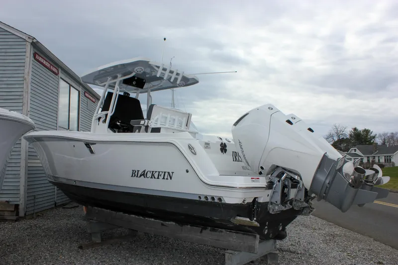 Slide: The Image of 2023 Blackfin 252 CC boat on display, featuring sleek design and powerful outboard engine. - 2