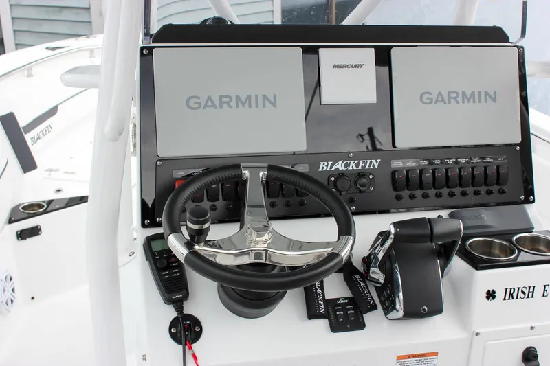 Slide: The Image of 2023 Blackfin 252 CC boat dashboard with Garmin displays and steering wheel. - 20