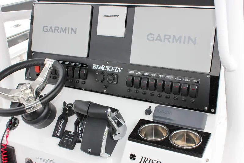 Slide: The Image of 2023 Blackfin 252 CC boat dashboard with Garmin displays and Mercury controls. - 21