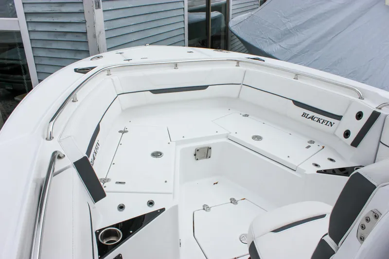 Slide: The Image of 2023 Blackfin 252 CC boat interior with white seating and storage compartments. - 24