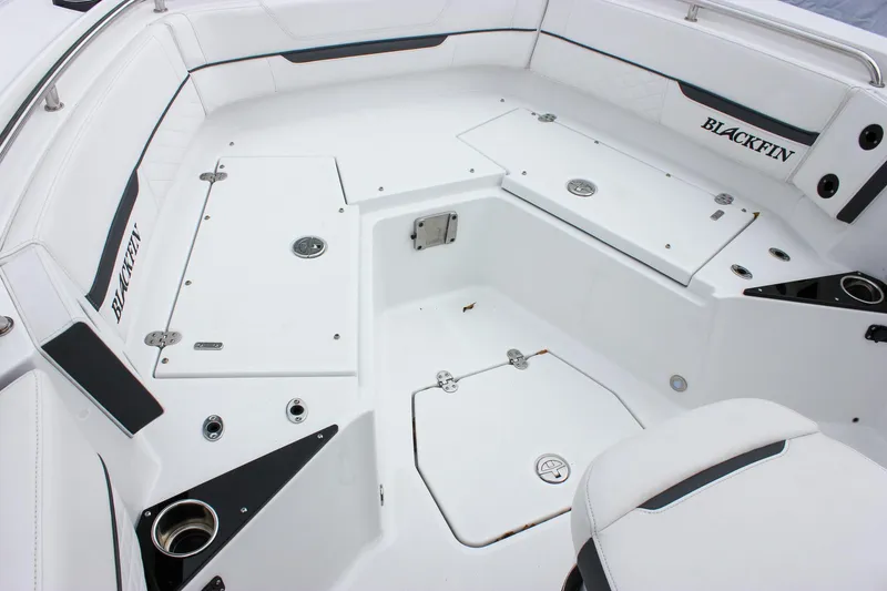 Slide: The Image of 2023 Blackfin 252 CC boat interior with white seating and storage compartments. - 25
