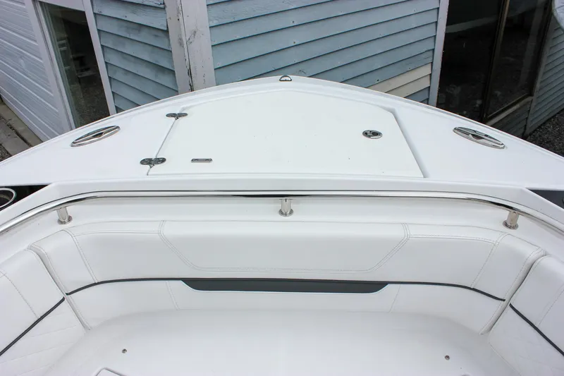 Slide: The Image of 2023 Blackfin 252 CC boat bow with white seating and storage compartments. - 27