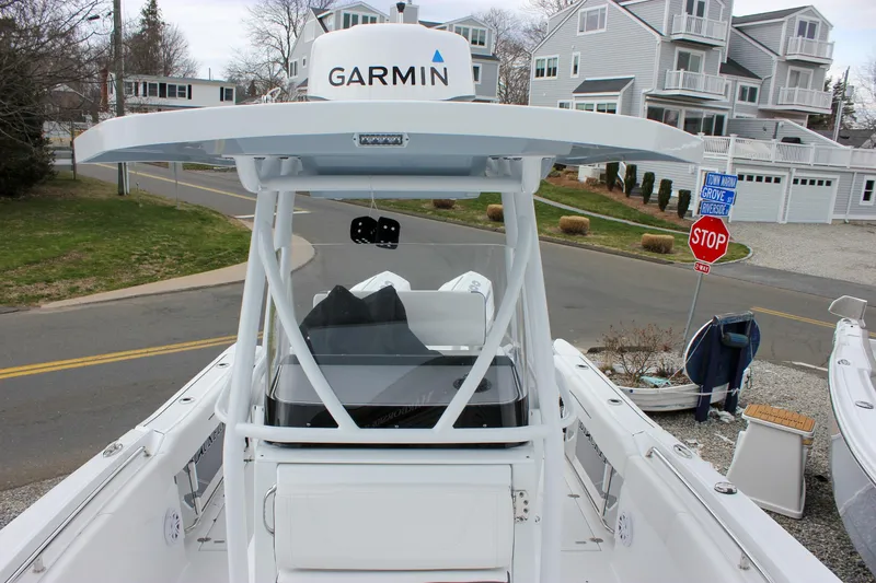 Slide: The Image of 2023 Blackfin 252 CC boat with Garmin equipment, docked near residential area. - 31
