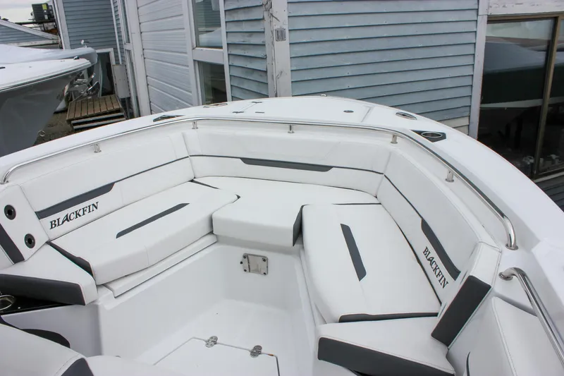 Slide: The Image of 2023 Blackfin 252 CC boat interior with white cushioned seating and sleek design. - 37