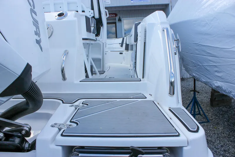 Slide: The Image of 2023 Blackfin 252 CC boat deck with Mercury engine, featuring sleek design and modern amenities. - 4