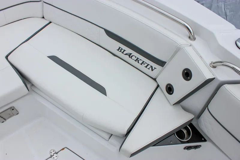 Slide: The Image of 2023 Blackfin 252 CC boat interior seating with sleek white upholstery and branded logo. - 40