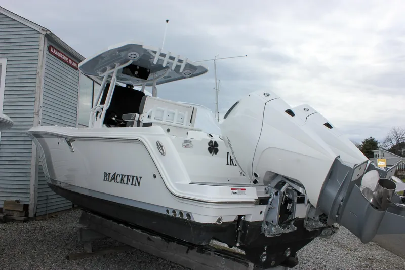 Slide: The Image of 2023 Blackfin 252 CC boat with dual outboard engines, displayed outdoors. - 44