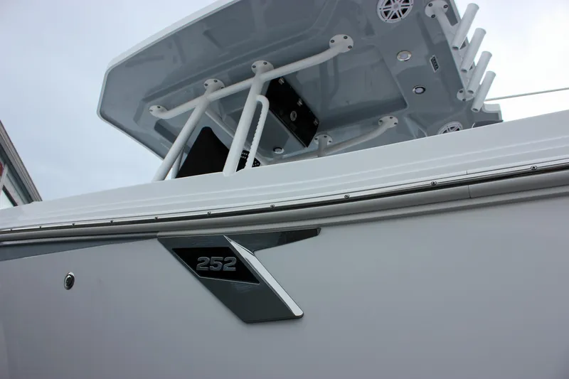Slide: The Image of 2023 Blackfin 252 CC boat, close-up of sleek design and logo. - 45