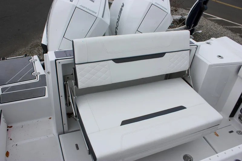 Slide: The Image of 2023 Blackfin 252 CC boat with white cushioned seating and dual outboard motors. - 9