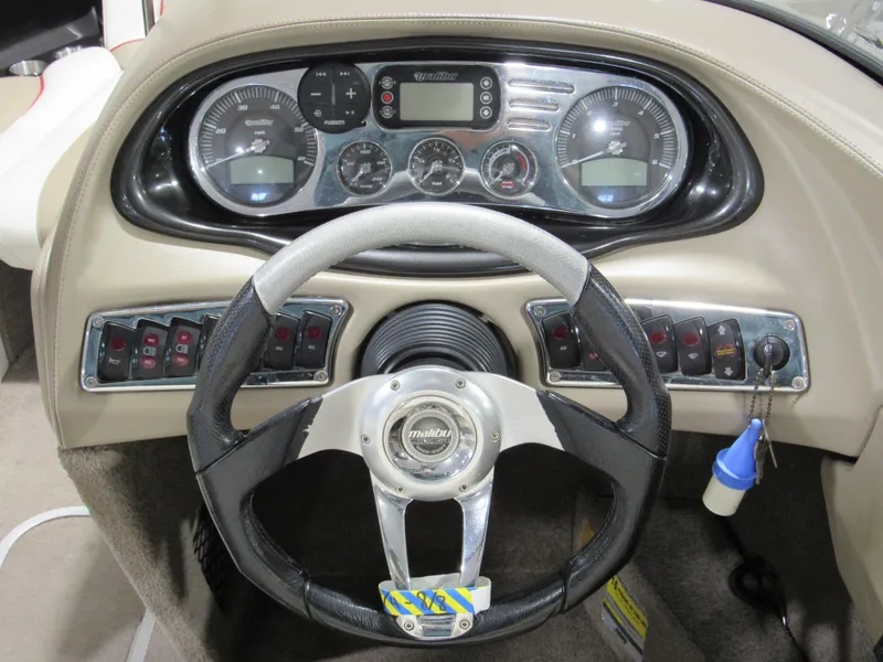 Slide: The Image of 2007 Malibu Wakesetter 247 LSV dashboard with steering wheel and control panel. - 10