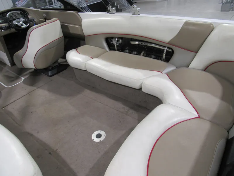 Slide: The Image of 2007 Malibu Wakesetter 247 LSV interior with beige and white seating, red accents. - 5