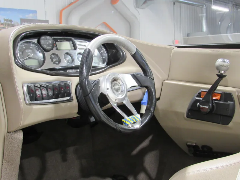 Slide: The Image of 2007 Malibu Wakesetter 247 LSV dashboard with steering wheel and control panel. - 9