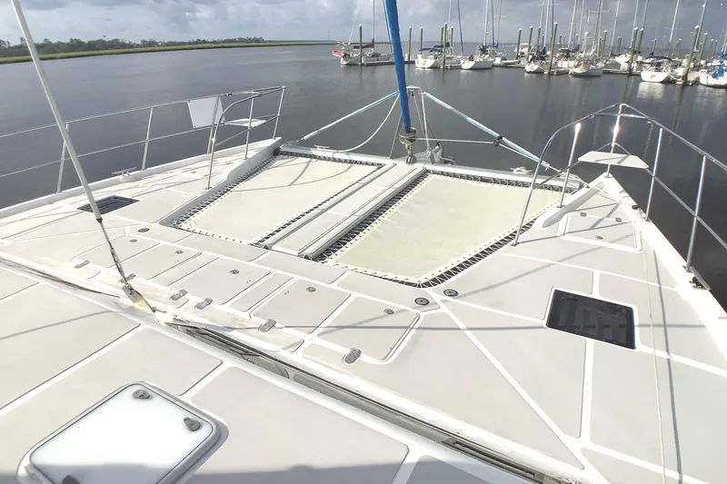 Slide: The Image of 2021 Royal Cape Catamarans Majestic 570 Flybridge, spacious deck with marina view. - 12