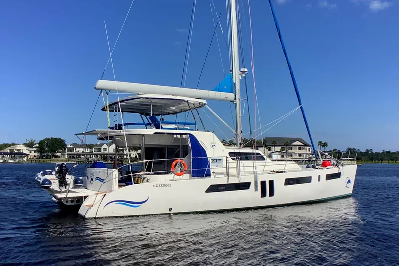 Slide: The Image of 2021 Royal Cape Catamarans Majestic 570 Flybridge sailing on calm waters. - 2