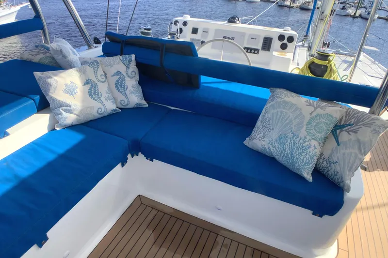Slide: The Image of Luxurious seating on 2021 Royal Cape Catamarans Majestic 570 Flybridge with nautical-themed cushions. - 25