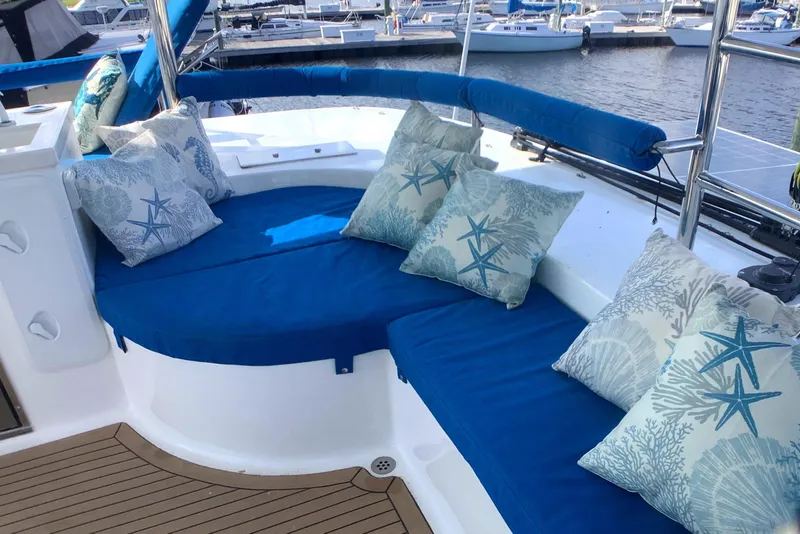 Slide: The Image of Luxurious seating area on 2021 Royal Cape Catamarans Majestic 570 Flybridge with nautical-themed cushions. - 26
