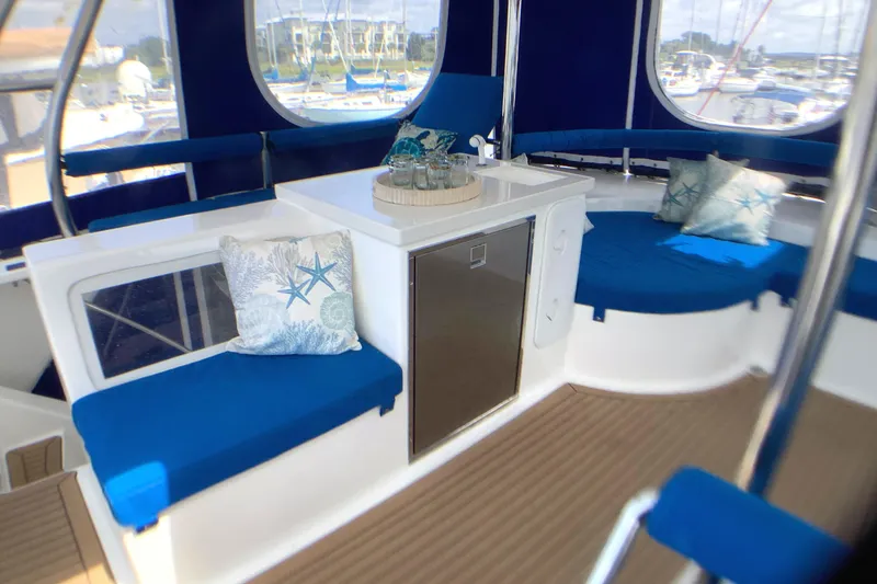 Slide: The Image of Luxurious interior of 2021 Royal Cape Catamarans Majestic 570 Flybridge with blue seating and cushions. - 28