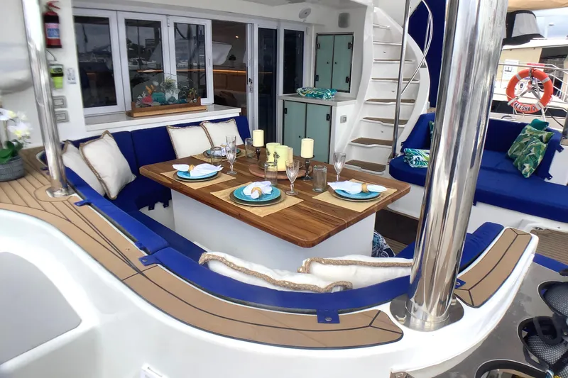 Slide: The Image of Luxurious 2021 Royal Cape Catamarans Majestic 570 Flybridge with elegant outdoor dining setup. - 39