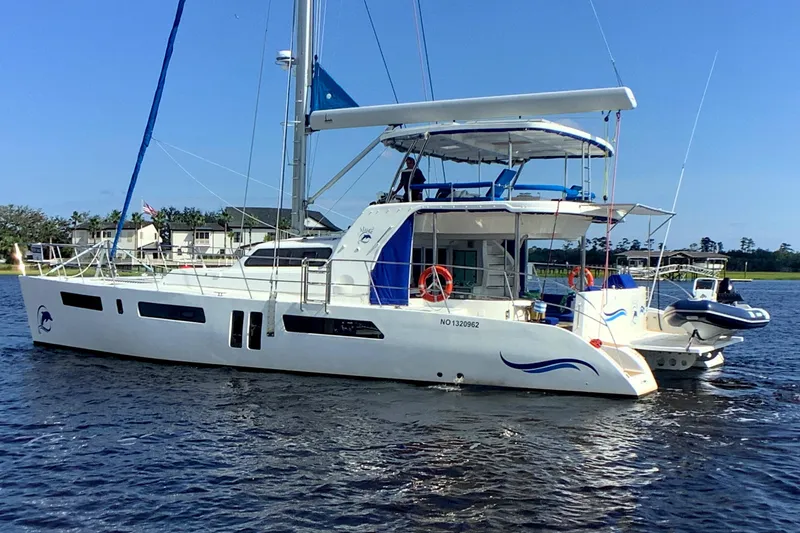 Slide: The Image of 2021 Royal Cape Catamarans Majestic 570 Flybridge on calm water, showcasing sleek design. - 4