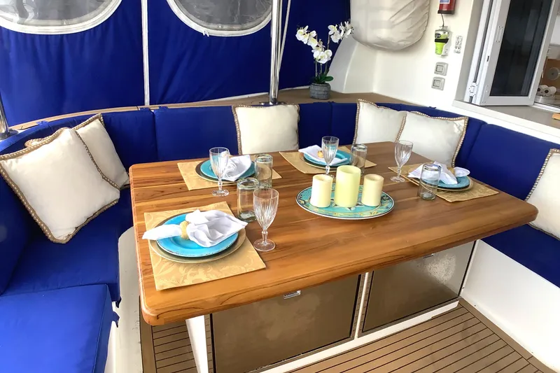 Slide: The Image of Luxurious dining area on 2021 Royal Cape Catamarans Majestic 570 Flybridge with elegant table setting. - 40