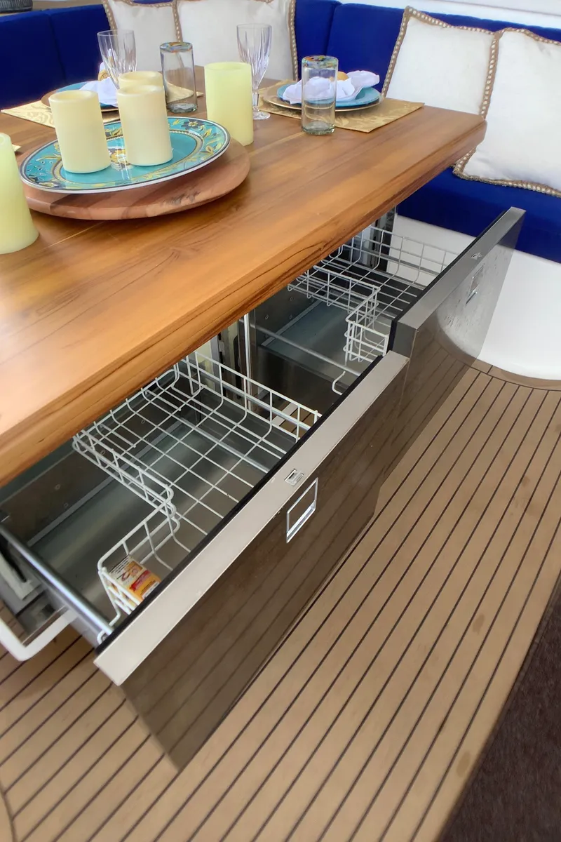 Slide: The Image of Built-in dishwasher on Royal Cape Catamarans Majestic 570 Flybridge, 2021 model, with elegant dining setup. - 41