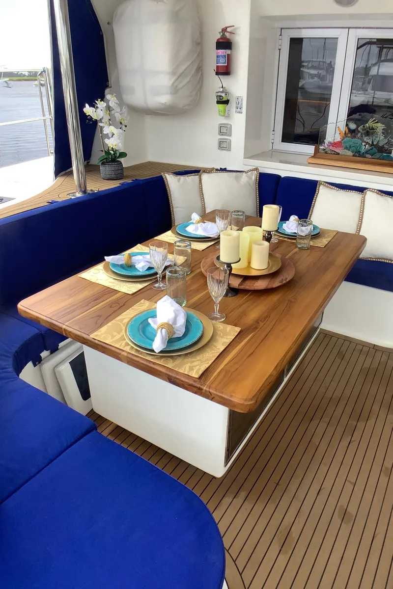 Slide: The Image of Luxurious dining area on 2021 Royal Cape Catamarans Majestic 570 Flybridge with elegant table setting. - 43