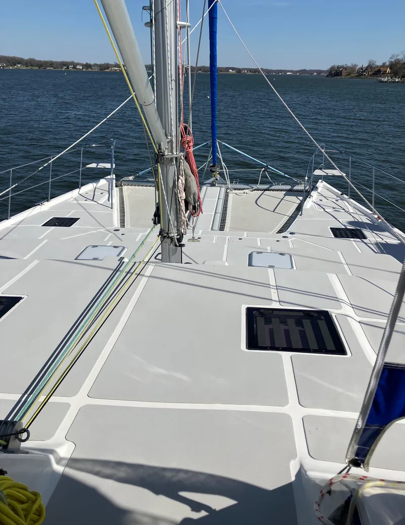 Slide: The Image of 2021 Royal Cape Catamarans Majestic 570 Flybridge on water, showcasing spacious deck and mast. - 5