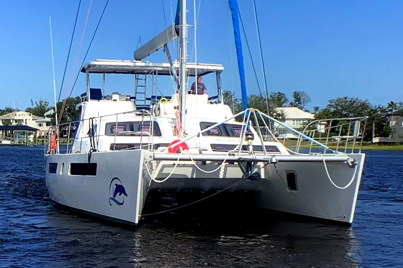 Slide: The Image of 2021 Royal Cape Catamarans Majestic 570 Flybridge on water, showcasing sleek design and spacious deck. - 7