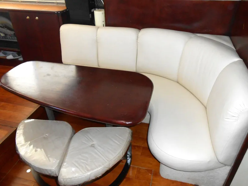 Slide: The Image of 1999 Silverton 352 MY yacht interior with white seating and wooden table. - 10