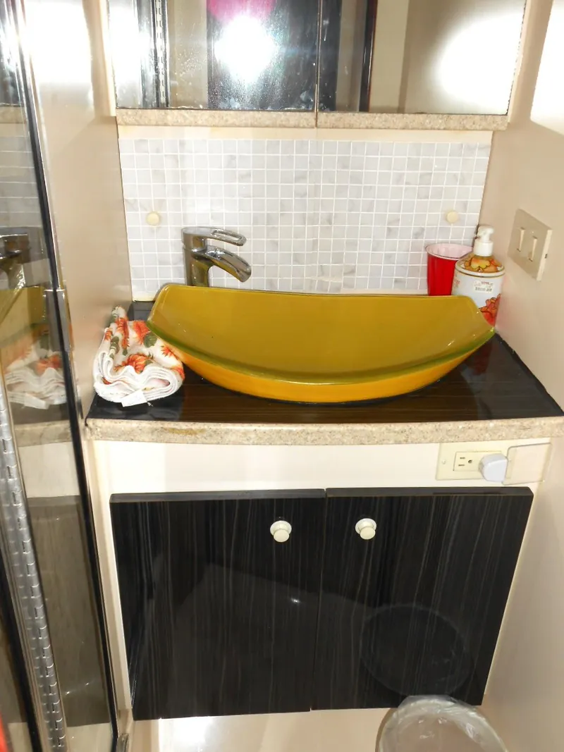 Slide: The Image of 1999 Silverton 352 MY bathroom with modern yellow sink and black cabinet. - 12