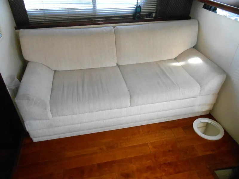 Slide: The Image of White sofa in 1999 Silverton 352 MY yacht interior, wooden floor, window blinds. - 13