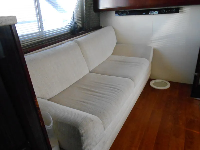 Slide: The Image of Interior of 1999 Silverton 352 MY yacht with white sofa and wooden flooring. - 15