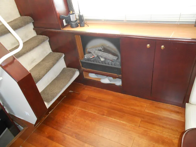 Slide: The Image of Interior of 1999 Silverton 352 MY yacht with wooden flooring and carpeted stairs. - 16