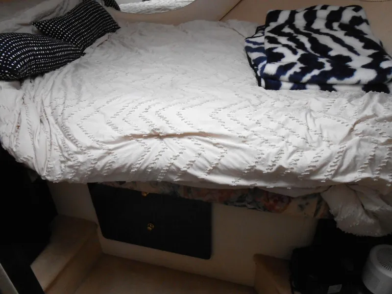 Slide: The Image of Cozy bedroom interior of 1999 Silverton 352 MY yacht with patterned bedding. - 18