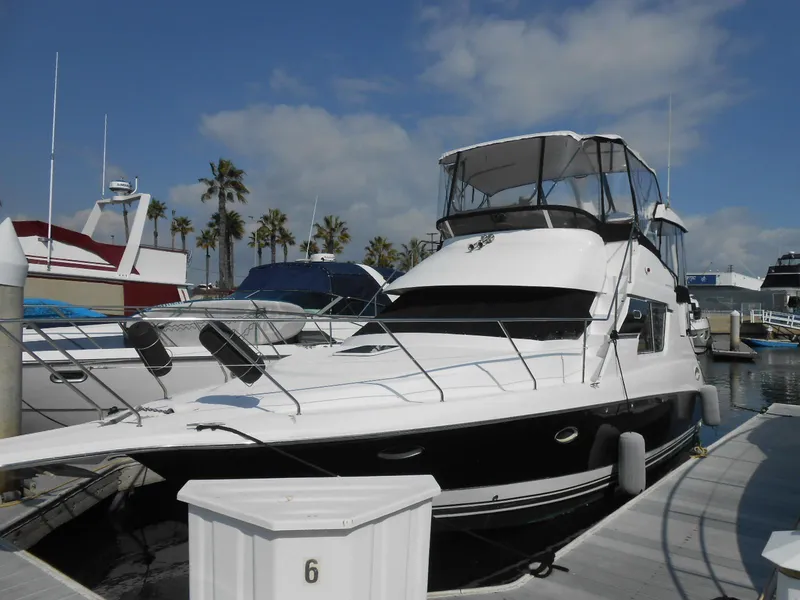 Slide: The Image of 1999 Silverton 352 MY yacht docked at marina with palm trees in background. - 3