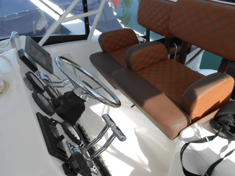 Slide: The Image of 1999 Silverton 352 MY helm with brown leather seats and modern controls. - 4