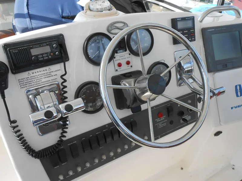 Slide: The Image of 1999 Silverton 352 MY boat helm with steering wheel, gauges, and navigation equipment. - 5