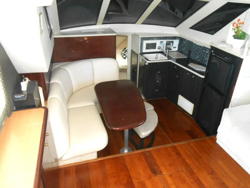 Slide: The Image of Interior of 1999 Silverton 352 MY yacht with dining area and kitchenette. - 8
